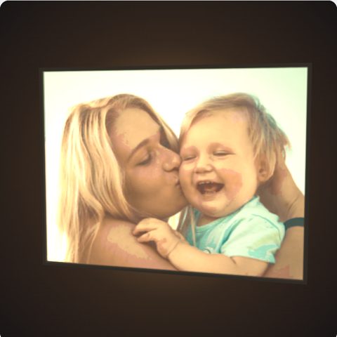 A full colour lithophane of a mum kissing her baby, glowing with light behind it